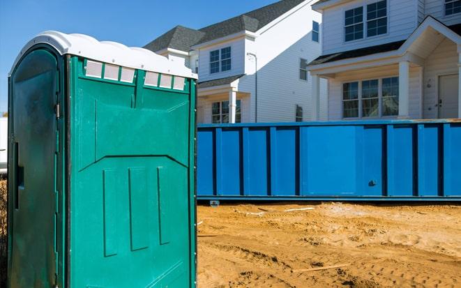 portable toilet and dumpster at a construction site in Upland CA